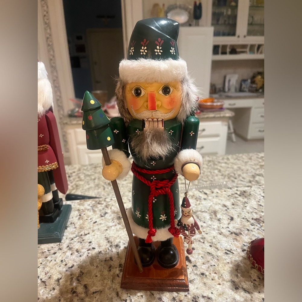 Green Santa Nutcracker with Christmas tree staff and puppet.